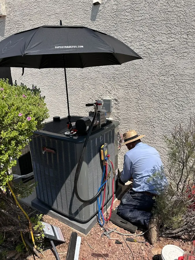 HVAC technician performing outdoor AC maintenance in Ormond-by-the-Sea